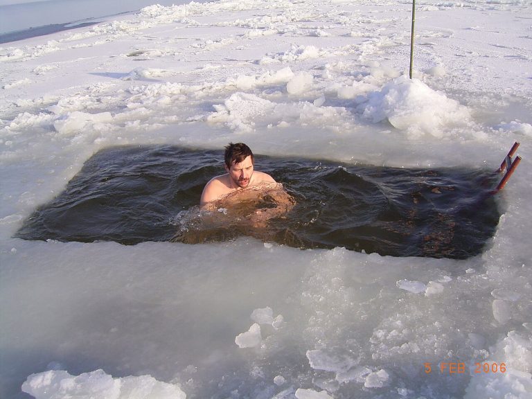 A winter swimmer in an opening in the ice in Latvia.