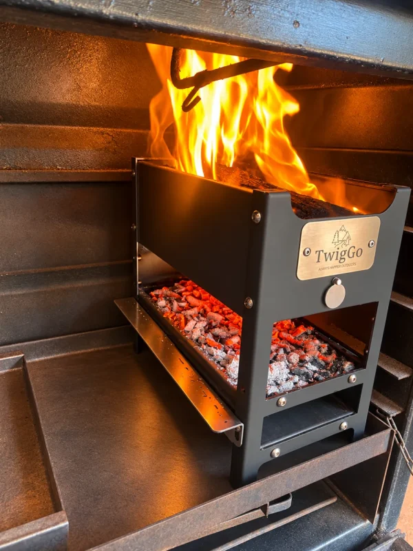 TwigGo Ember Oven 3 TwigGo Ember Oven with flames burning in the firebox